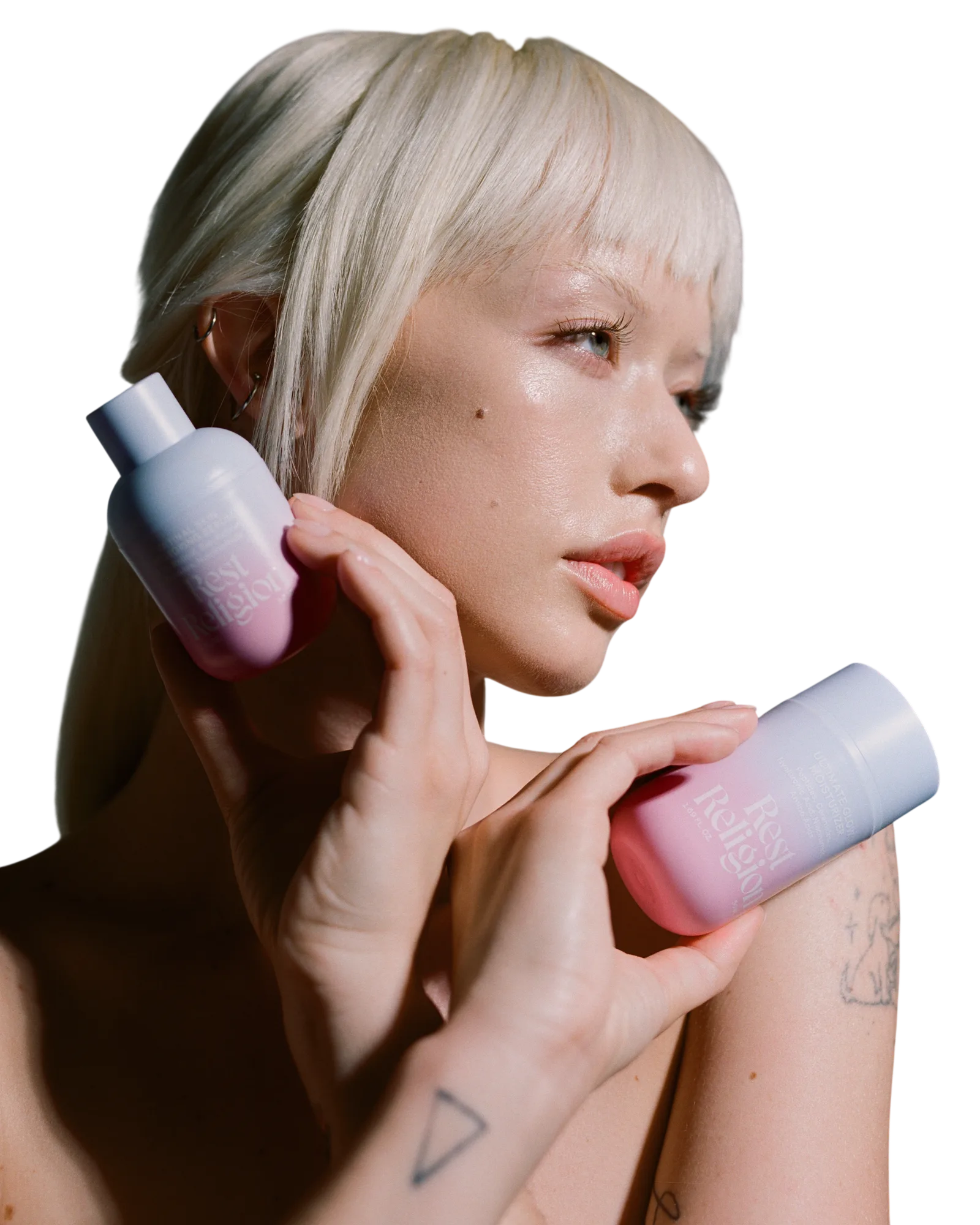 Model holding Rest Religion Retinal Serum and Moisturizer